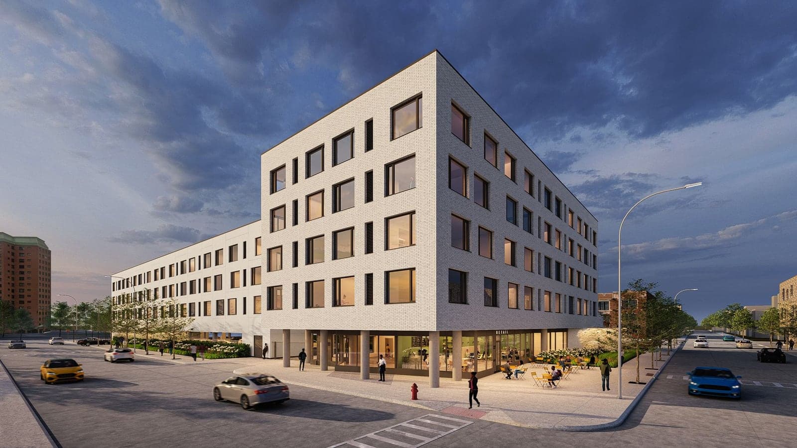 Rendering of a five-story white brick apartment building at a street corner at dusk, with a glass ground floor, outdoor tables and a lower wing running along the side street