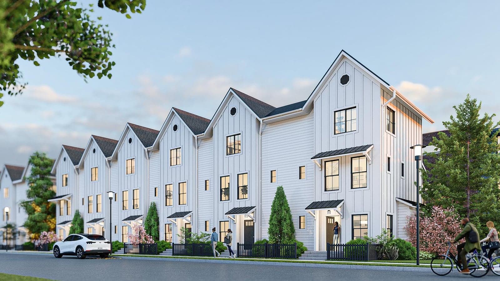 Rendering of a row of white three-story townhomes with steep gabled roofs, black-framed windows and small entry canopies along a street, with a cyclist and people walking