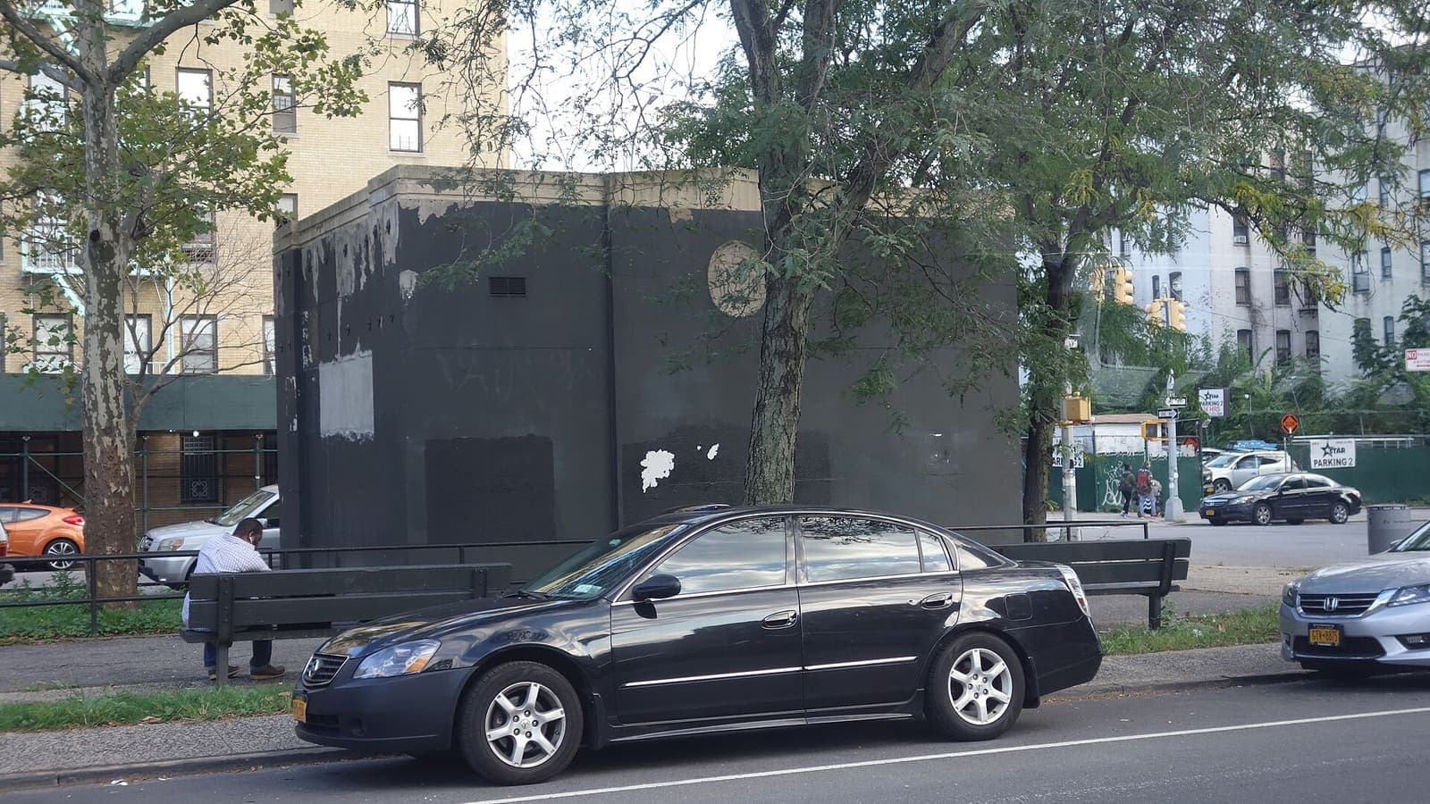 A utility building and street trees beside Crotona Parkway Malls in Belmont, the Bronx