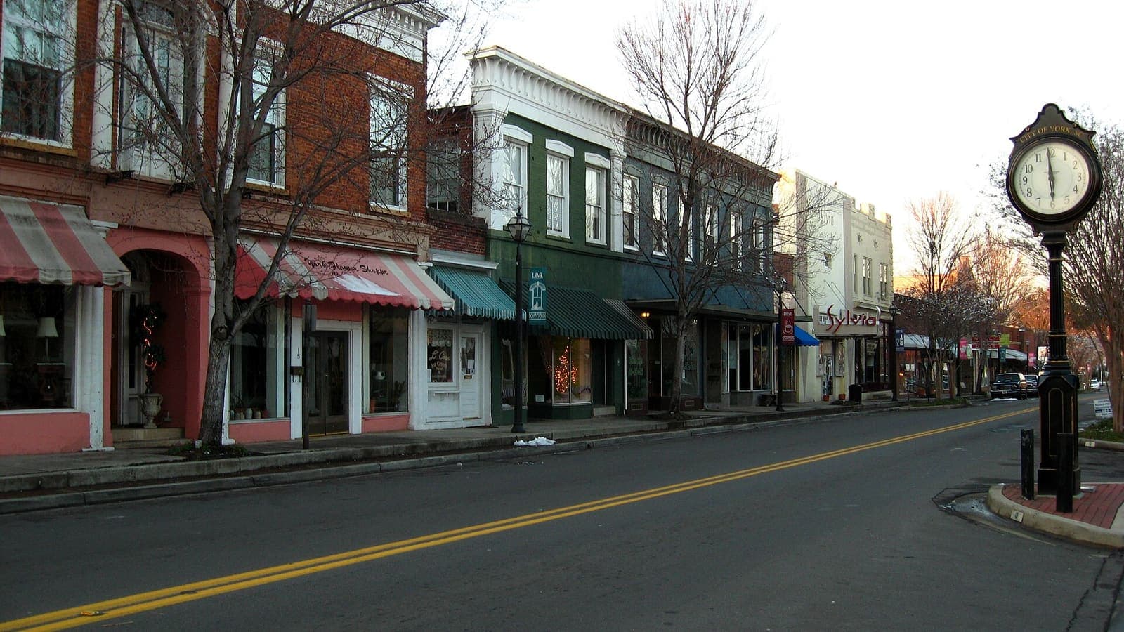 Brick storefronts and a street clock in downtown York, South Carolina