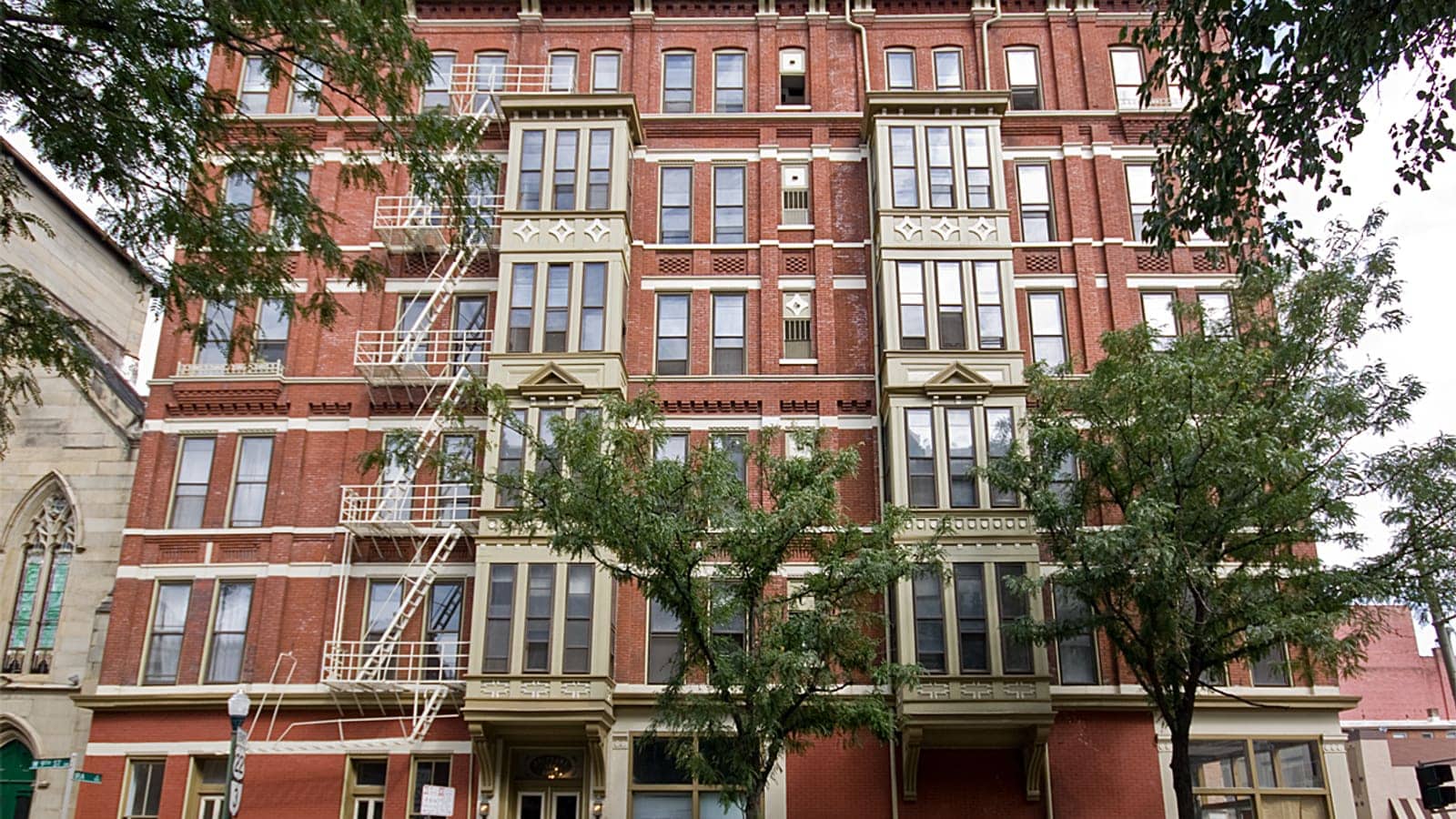 The brick facade and bay windows of Brittany Apartments in Cincinnati, Ohio