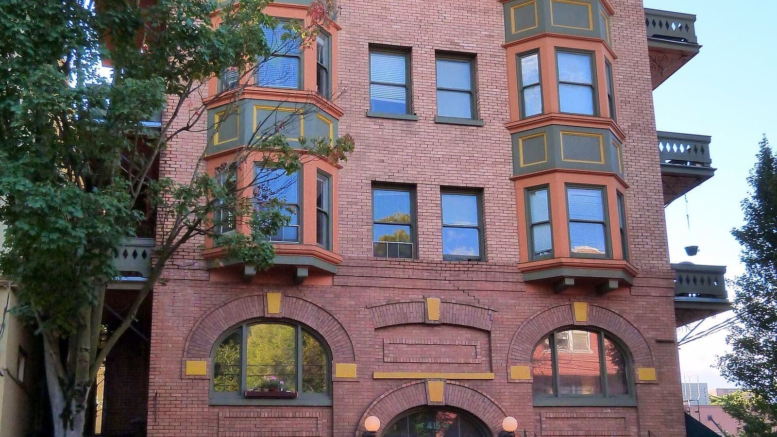 The brick facade and bay windows of the Buck Apartment Building in Portland, Oregon
