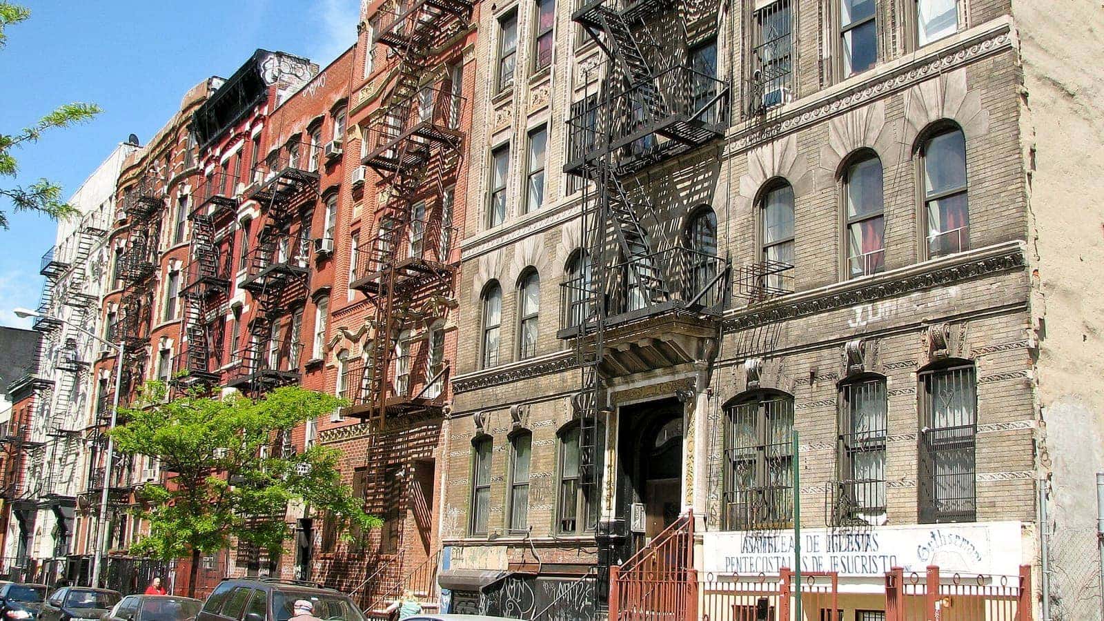 Exterior fire escapes along a row of New York City apartment buildings