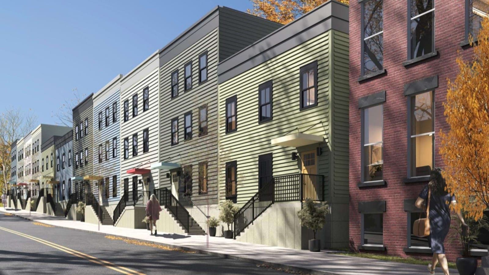 Rendering of a row of three-story buildings with gray, blue and green siding, front stoops with black railings and a brick building at the right, seen from the street