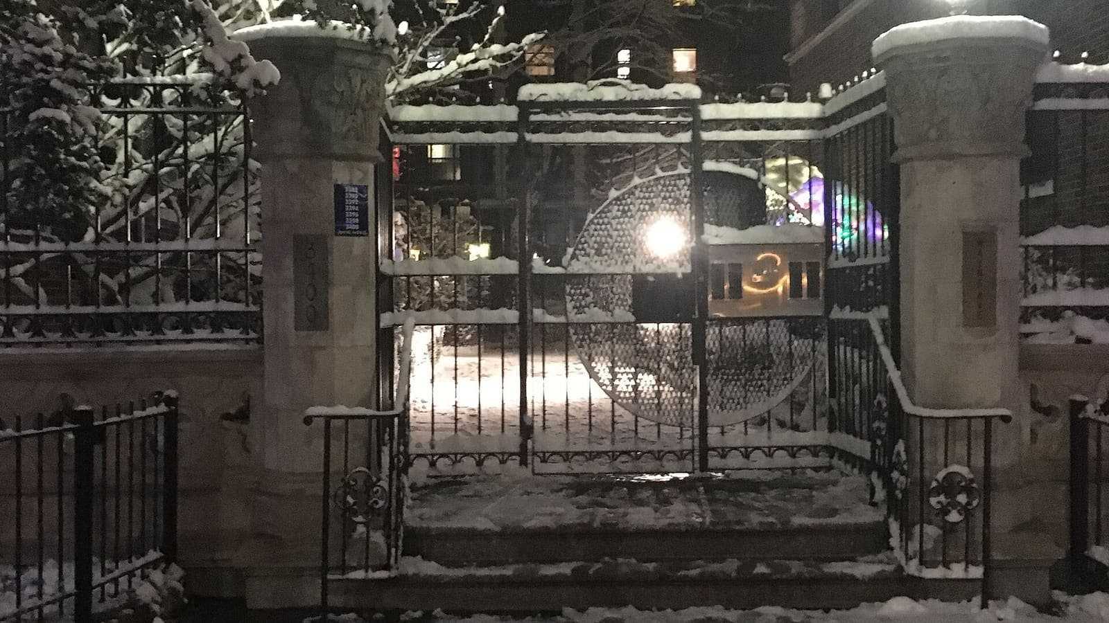 The entrance gates of the Lenru apartment building in the Bronx after snowfall