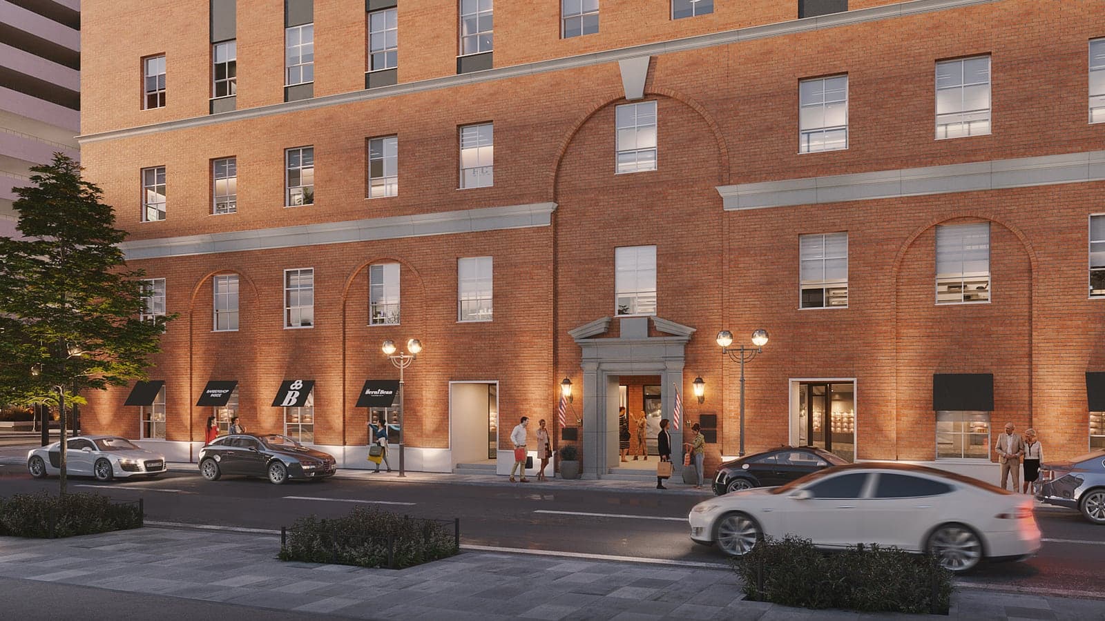 Rendering at dusk of the lower floors of a red brick building with arched brickwork, black awnings, a stone entrance lit by lamps, people on the sidewalk and cars passing