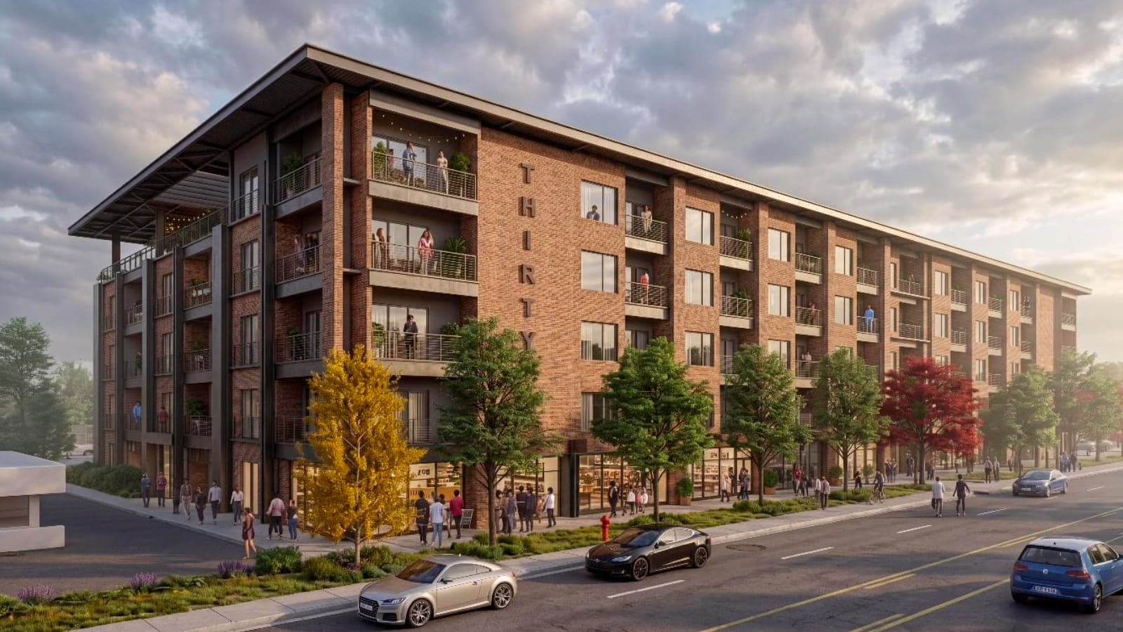Rendering of a five-story red brick apartment building with balconies, the word THIRTY lettered down one corner, storefronts at street level and trees along the sidewalk