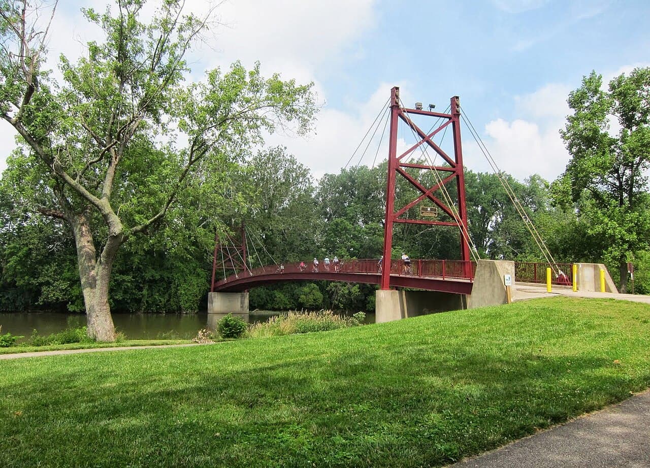 The red Gayle B. Price Jr. suspension bridge over the river in Dayton, photographed in 2013.