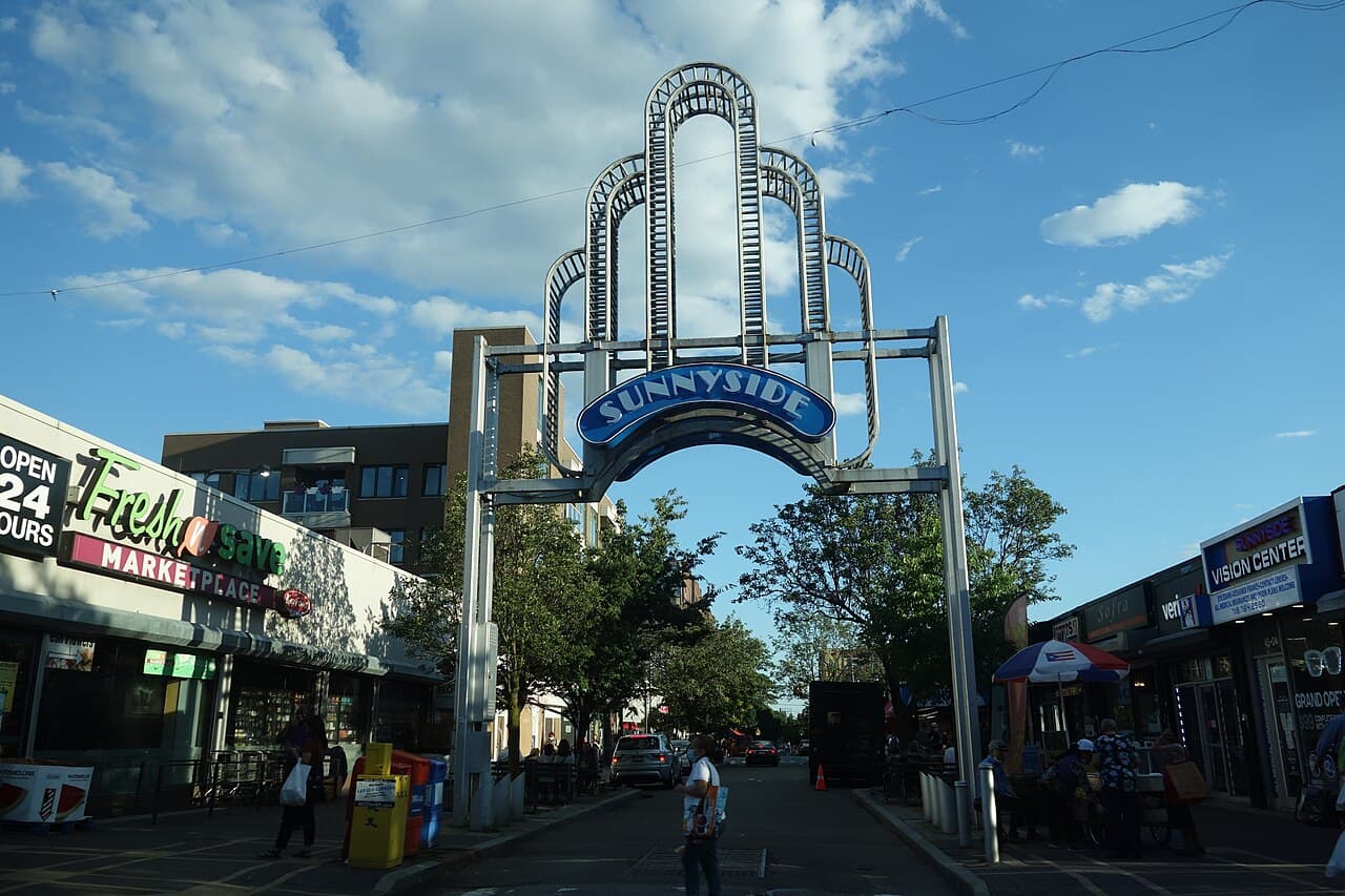The Sunnyside arch beside shops on Queens Boulevard at 46th Street in 2021.