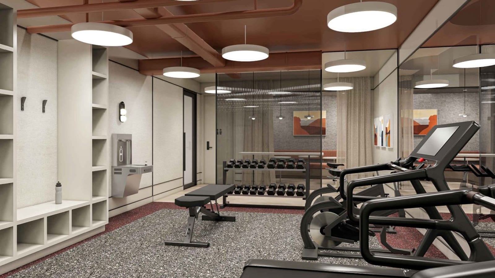 Rendering of a fitness room with a speckled rubber floor, a treadmill and exercise bikes on the right, a weight bench and a rack of dumbbells, cubby shelves and a water bottle filler on the left, round ceiling lights, and a glass wall to a lounge behind