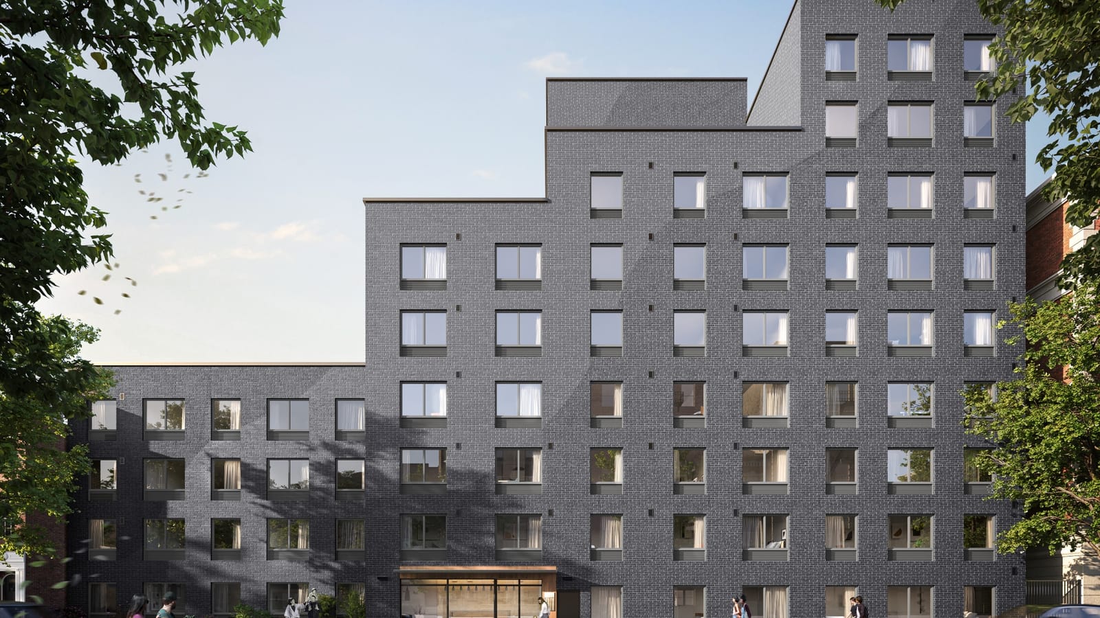 Rendering of a dark grey brick apartment building that steps up from four stories at the left to nine at the right, with rows of square two-pane windows, a glass entrance under a bronze-colored canopy at street level, pedestrians on the sidewalk and tree branches framing the view