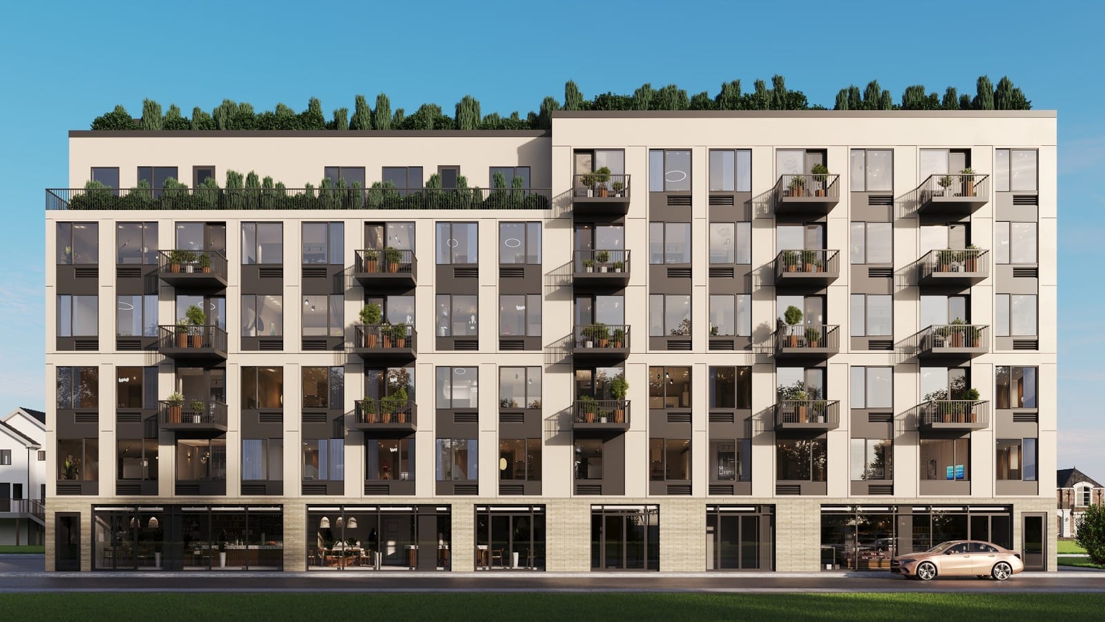 Rendering of a six-story building seen straight on, with cream-colored panels, dark gray window bands, small dark balconies with potted plants, a roof terrace with a railing on the left part, rows of trees along the roof, glass storefronts with tables and shelves on the ground floor, a gold sedan parked at the curb at right, a lawn in the foreground and houses at both edges, under a clear blue sky