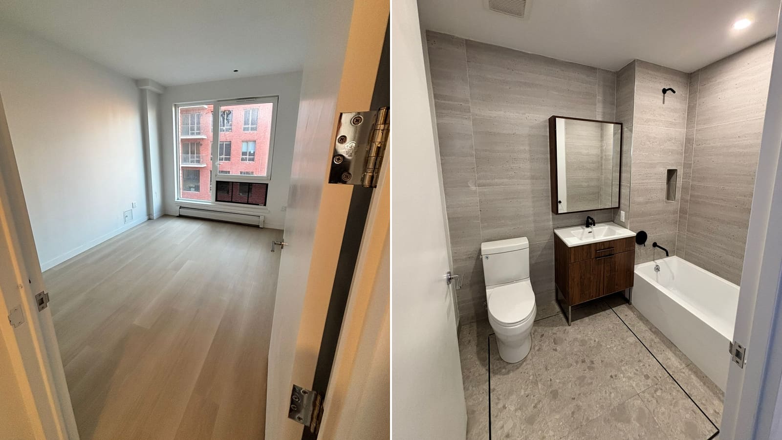 Two photographs side by side: at left an empty room seen through an open door, with pale wood-look flooring, white walls, a two-pane window looking onto a red-brick building with balconies, a louvered opening below the window and a baseboard unit along the wall; at right a bathroom with grey stone-look wall tile, a white toilet, a wood-tone vanity with a white sink and black faucet, a mirrored cabinet and a white bathtub with black fixtures