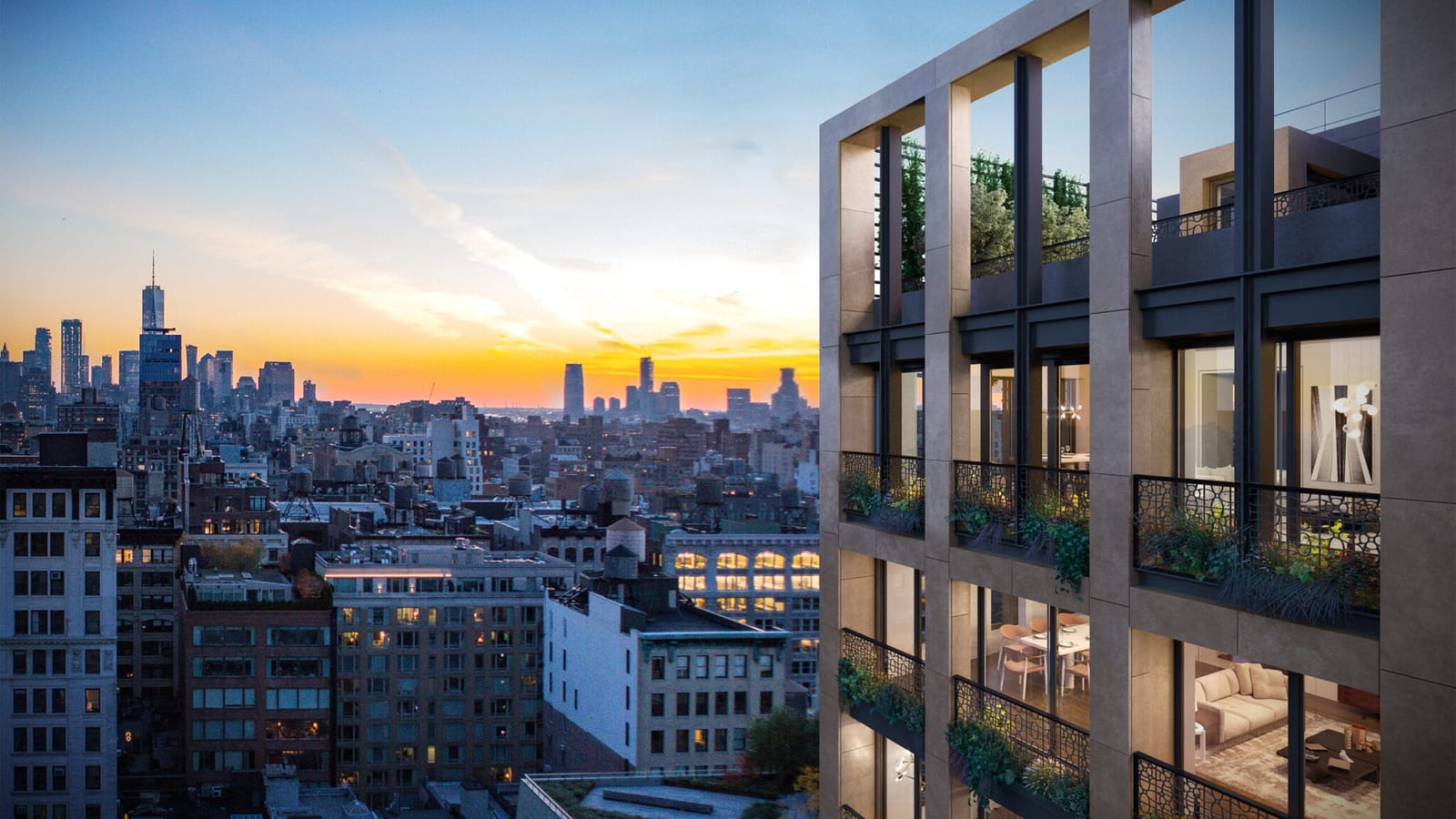 Rendering of the upper corner of a tower clad in gray-brown stone panels, with tall windows, dark metal frames and planted balconies behind patterned bronze-colored railings, lit rooms with a dining table and a sofa, and the lower Manhattan skyline and One World Trade Center under an orange sunset
