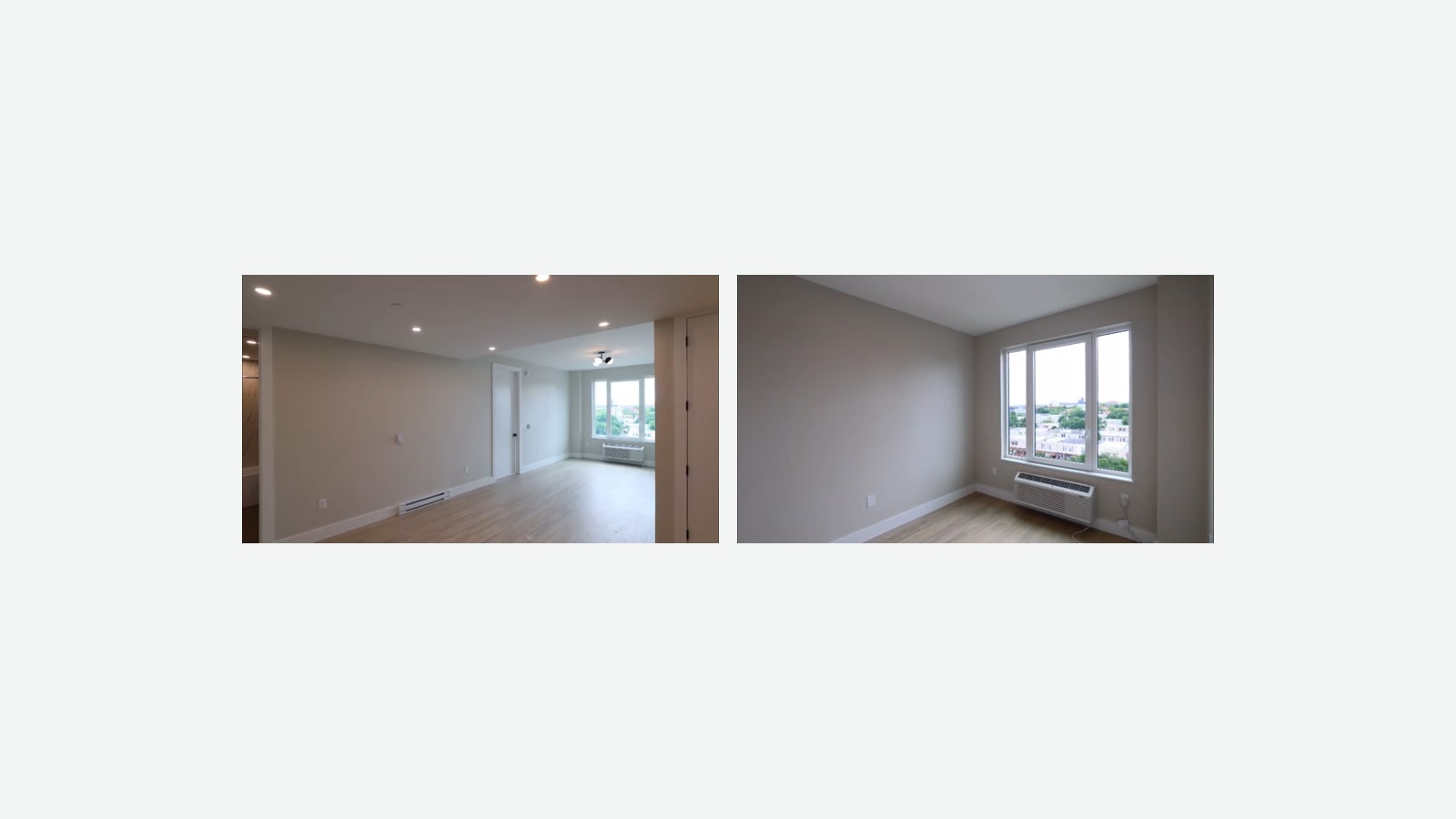 Two photographs side by side of empty rooms with light wood-look floors and pale walls: at left, a long living area with recessed lights, a baseboard heater and a window with a wall air conditioner at the far end; at right, a room with a large window over rooftops and trees and a wall air conditioner below it