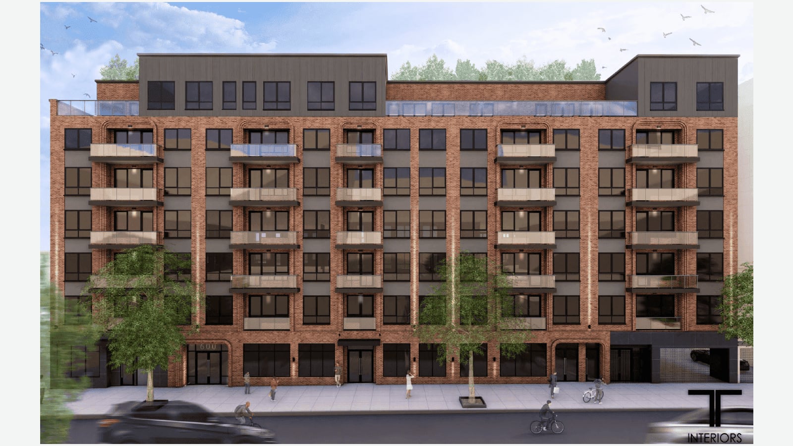 Rendering of a seven-story red brick apartment building with dark gray panels between the windows, small balconies with glass railings stacked in five columns, a dark set-back top floor, an entrance with the number 600 above it, shopfront windows on the ground floor and a garage opening at the right end, with street trees, cyclists and a few small figures on the sidewalk, shown on a plain light background with a TT Interiors logo in the lower right corner