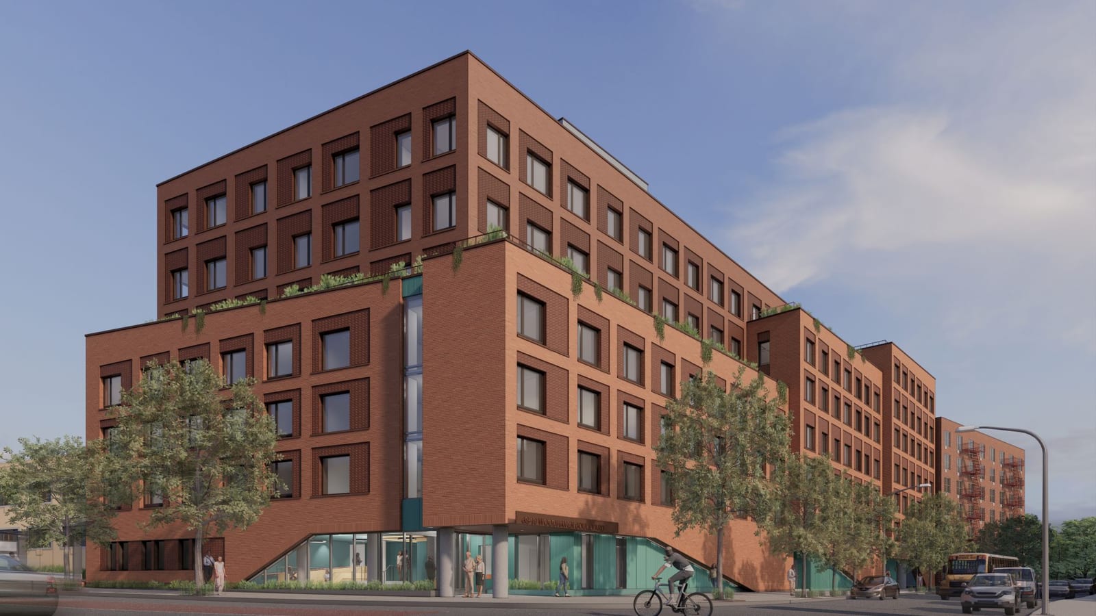 Rendering of a red brick apartment building on a street corner, with a grid of windows set in darker textured brick panels, planted setbacks stepping up from the corner, a glazed entrance with teal panels under a canopy on the ground floor, street trees, a cyclist in the foreground and a yellow school bus on the side street