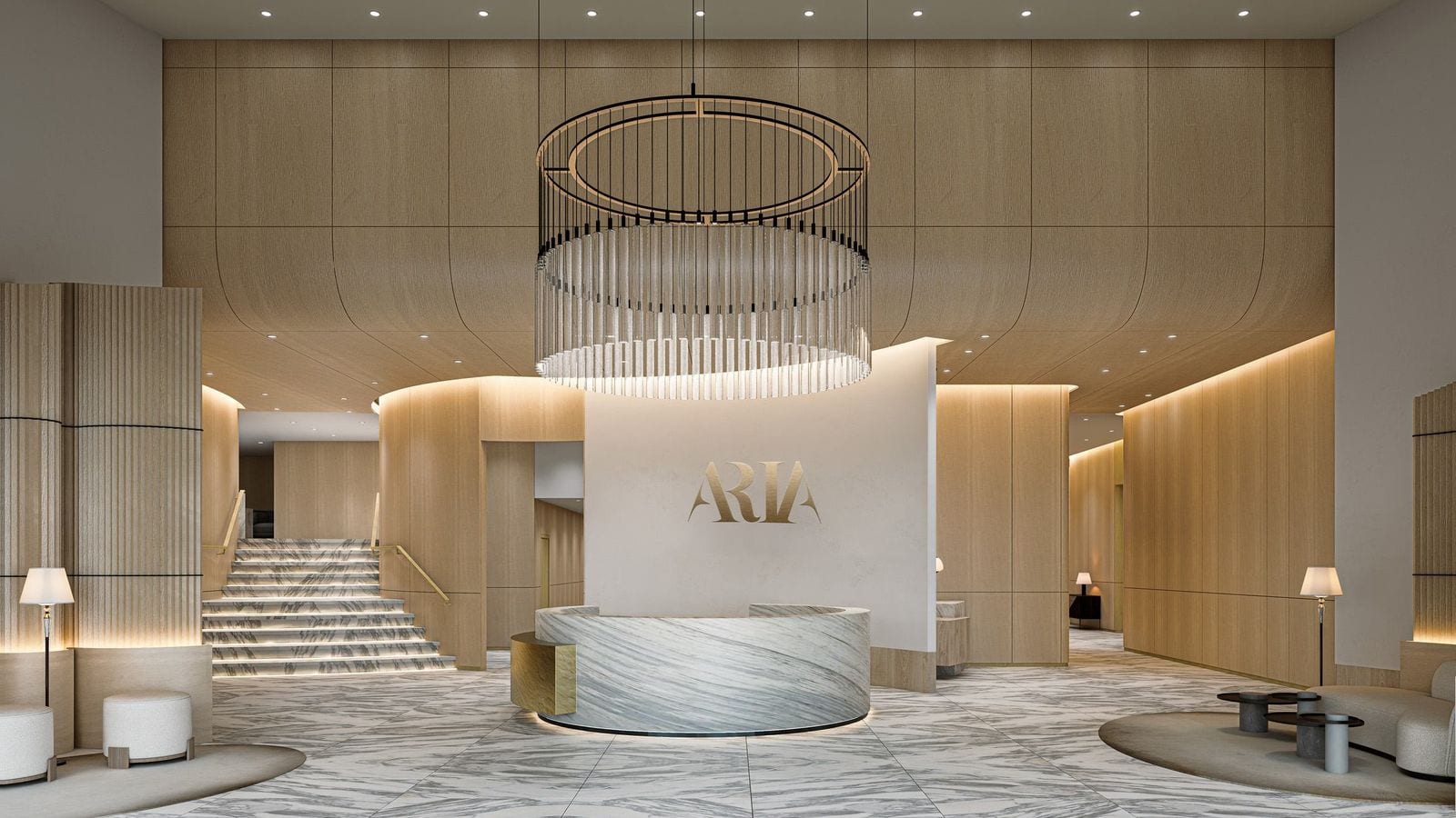 Rendering of a double-height lobby with pale wood wall panels, a white and grey marble floor, a round marble reception desk in front of a wall with gold ARIA lettering, a large ring-shaped chandelier above it and a marble staircase at the left