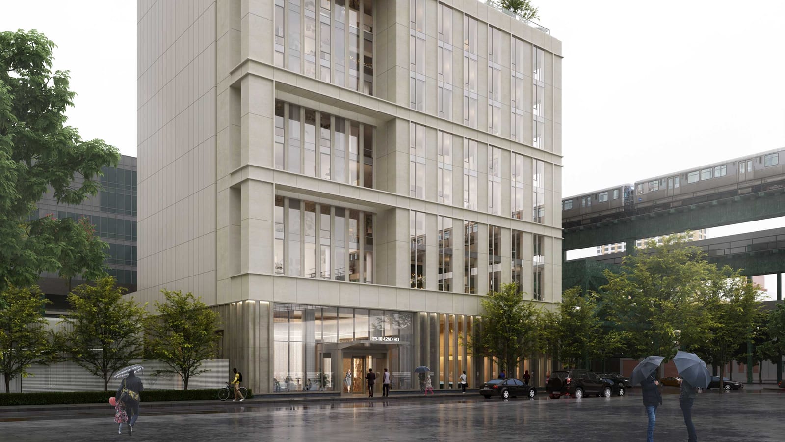 Rendering of the lower floors of a pale stone-colored tower with tall window bays, a glass lobby under a canopy marked 23-10 42nd Rd, trees and parked cars along a wet street, people with umbrellas, and an elevated subway train on a green steel structure at right
