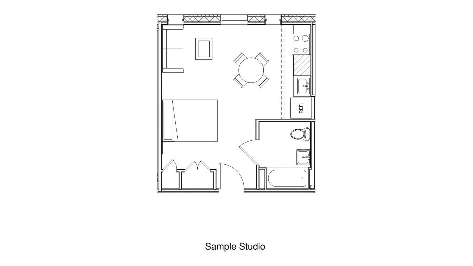 Floor plan line drawing of a studio apartment: one room with a sofa, a round table with four chairs and a bed, a kitchen wall with a four-burner range, sink and refrigerator, two closets, and a bathroom with a tub, toilet and sink; labeled Sample Studio