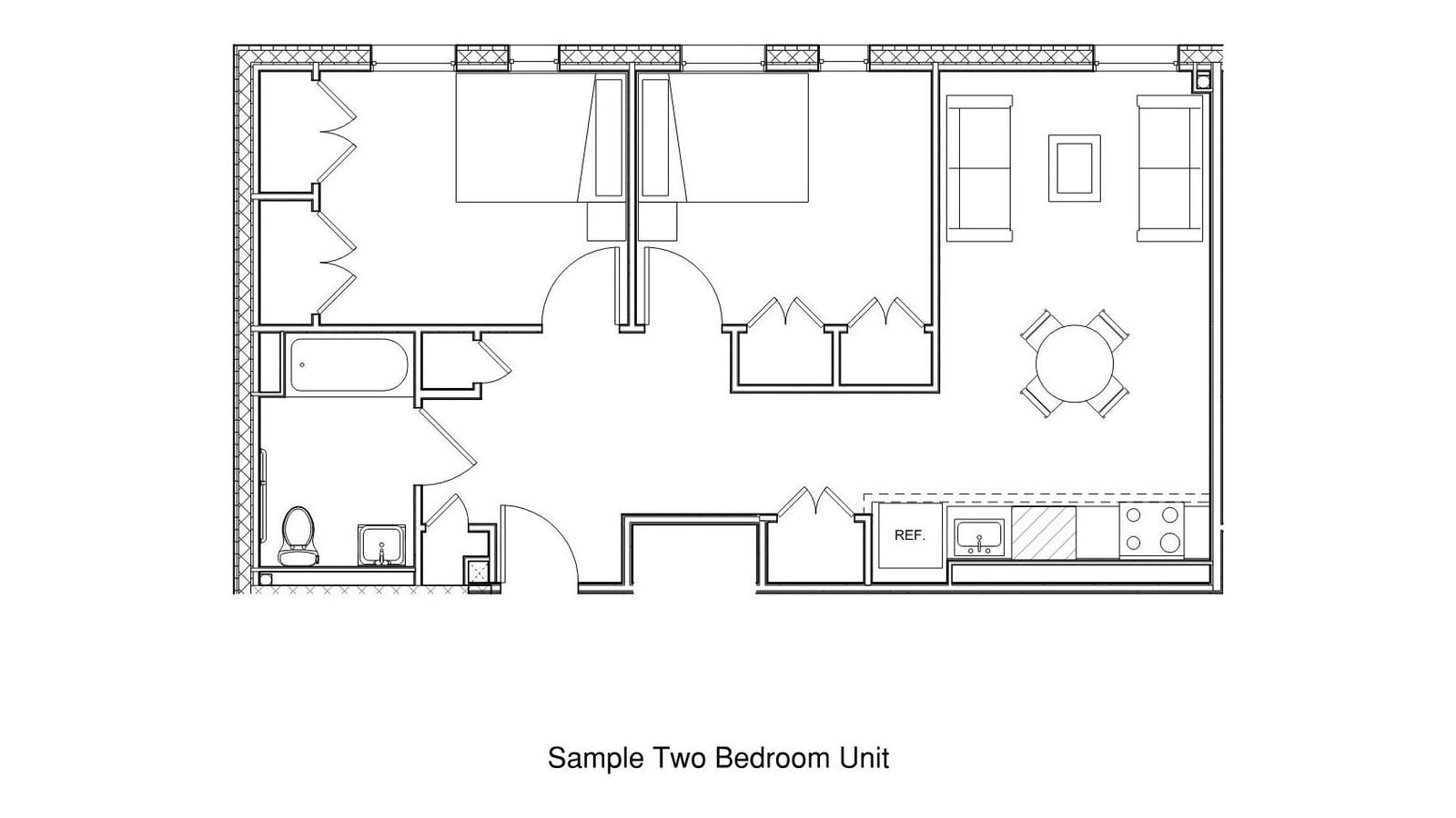 Floor plan line drawing of a two-bedroom apartment: two bedrooms side by side with closets, a bathroom with a tub, a hall closet, and a living and dining room with two sofas and a round table beside a wall kitchen with refrigerator, sink and four-burner range; labeled Sample Two Bedroom Unit