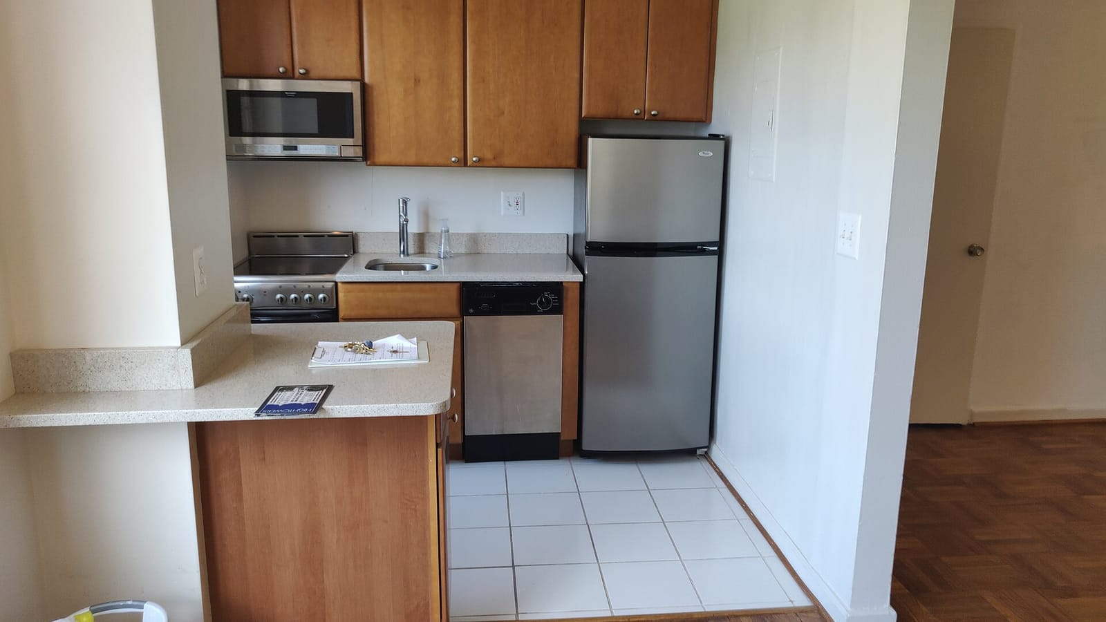 Apartment kitchen with a sink, oven and refrigerator