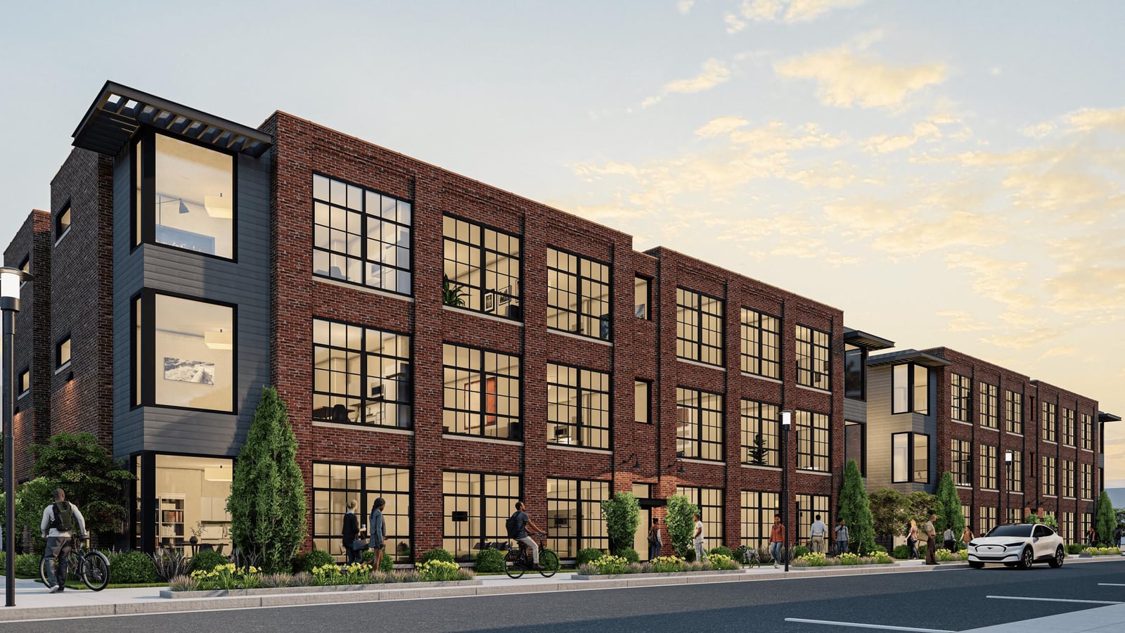 Rendering of two three-story red brick buildings with large black-framed windows and dark gray corner bays along a street, with people walking and cycling past