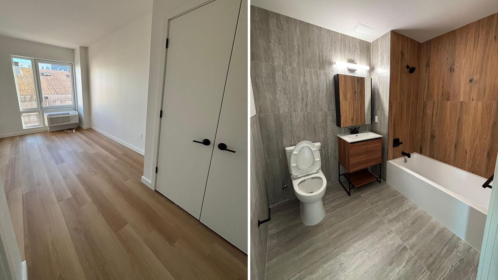 Two photographs side by side: at the left an empty bedroom with white walls, light wood-look plank flooring, white double closet doors with black handles and a two-pane window with a white unit set into the wall beneath it; at the right a bathroom with large grey stone-look tile on the floor and walls, wood-look tile around a white bathtub, black fixtures, a white toilet, and a small vanity and mirrored cabinet in a wood finish under a bar light
