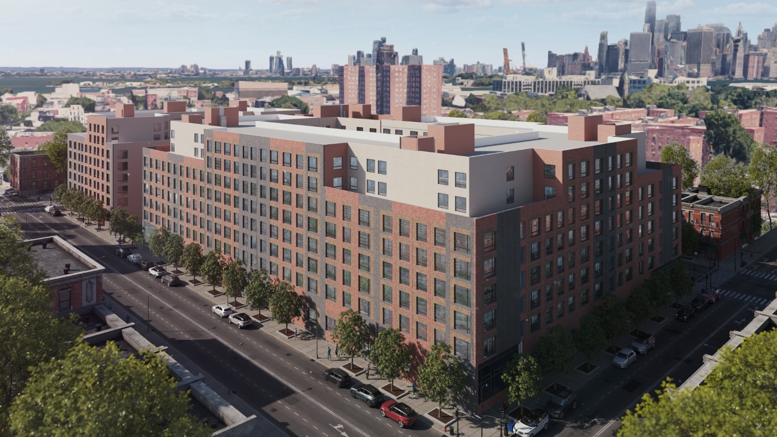 Aerial rendering of a long mid-rise apartment block faced in red, grey and tan brick with cream-colored upper floors set back from the street, filling a corner lot along a tree-lined street with parked cars, a second similar building beyond it at the left, brick towers behind and a skyline on the horizon