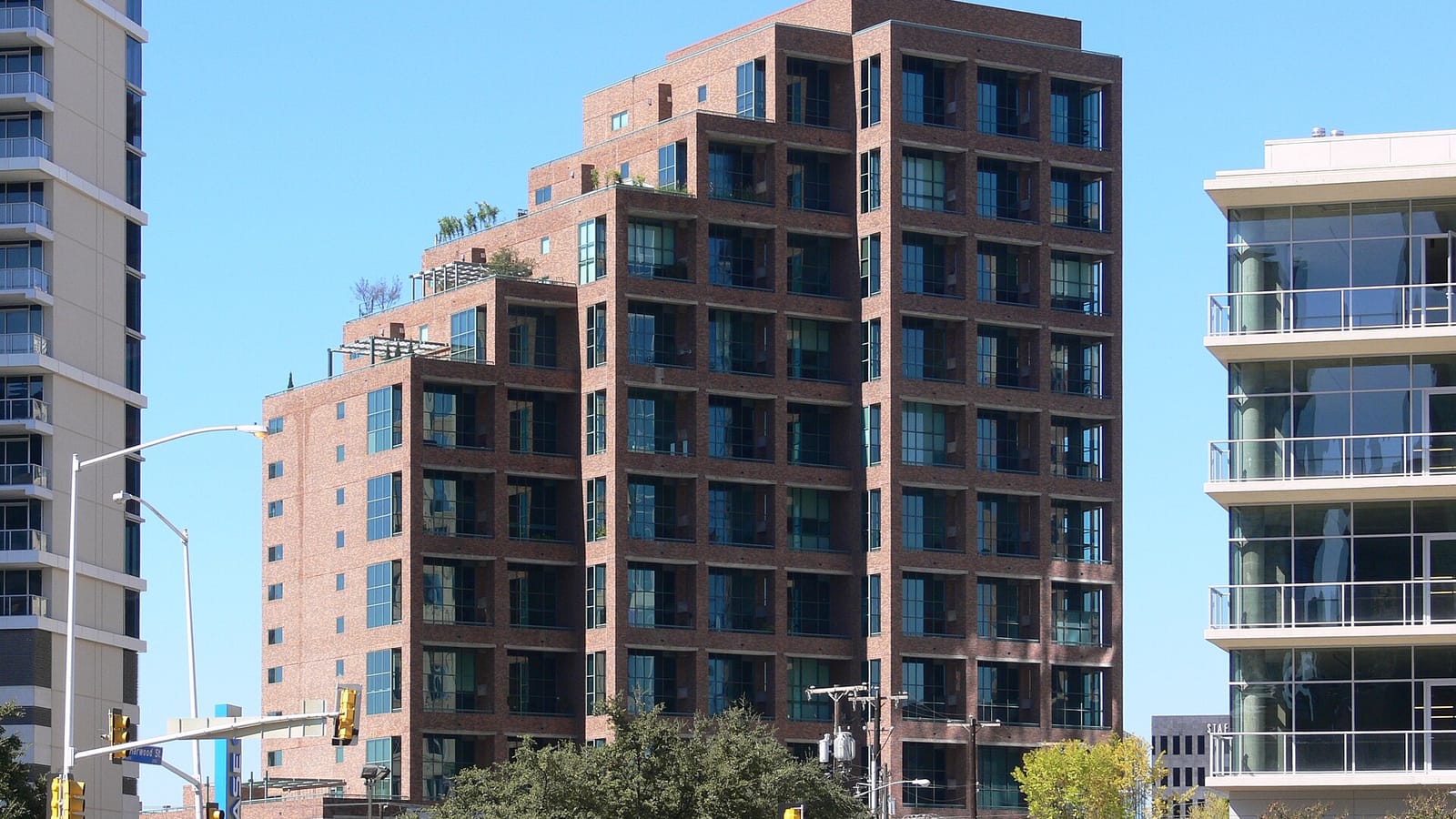 Stepped brick residential tower with large windows