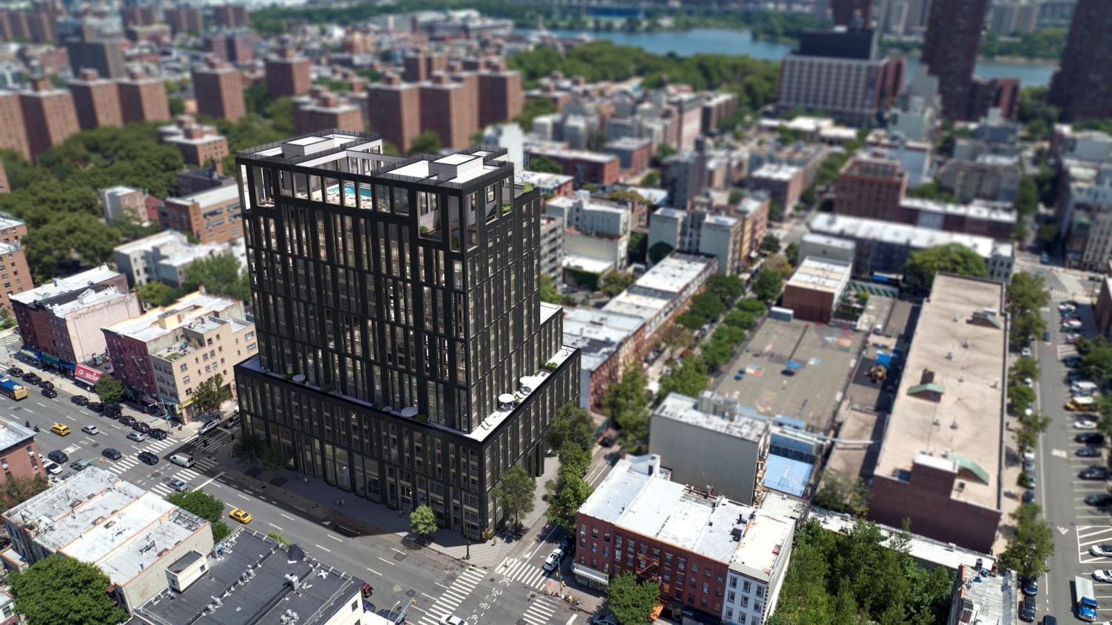 Aerial rendering of a dark 18-story apartment building with tall narrow windows, terraces on a setback partway up and a swimming pool on the roof, standing on a corner lot beside a wide avenue among low brick buildings, with brick apartment towers, trees and a river in the distance