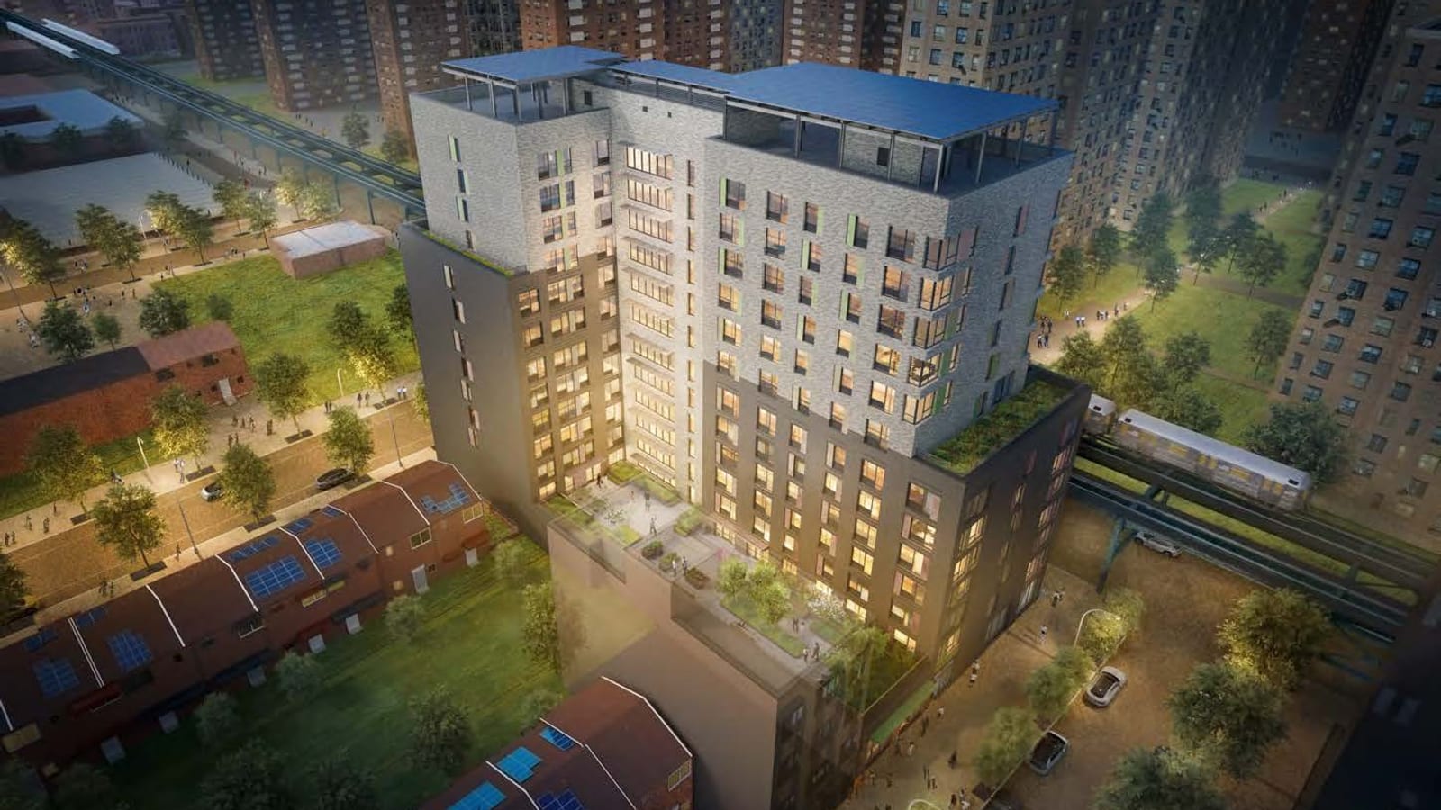 Rendering at dusk, seen from above, of a 13-story building with dark grey lower floors, light grey upper floors with green panels, solar panels on the roof and a planted terrace, between rows of houses with solar panels and a raised subway line, with tall brick apartment towers behind