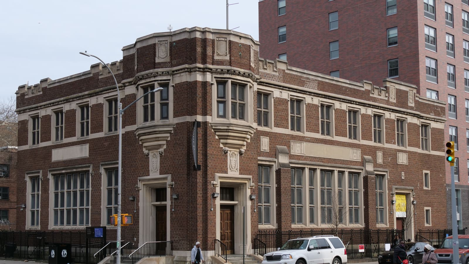 The brick and limestone Stone Avenue Library on a street corner in Brownsville, Brooklyn