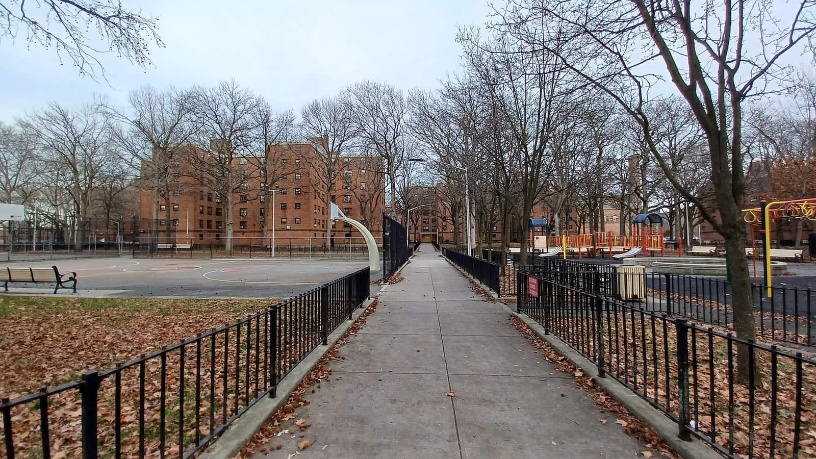 Walkway between residential buildings and a playground