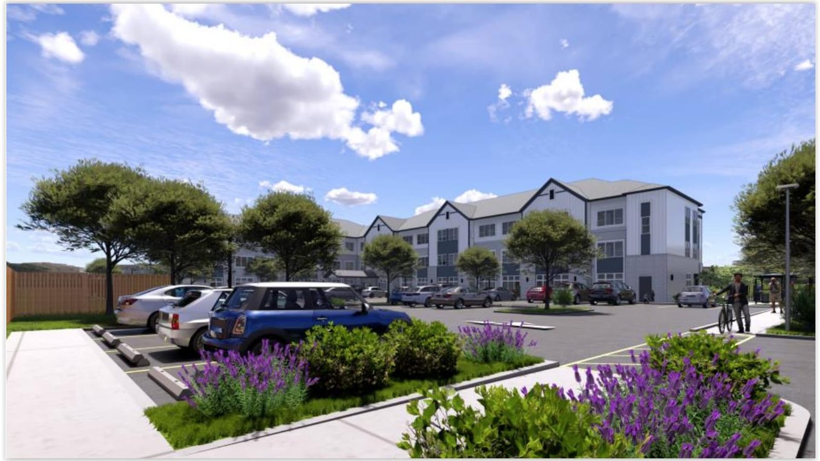 Rendering of the back of a three-story apartment building seen across a parking lot with parked cars, a wooden fence and purple flowering plants