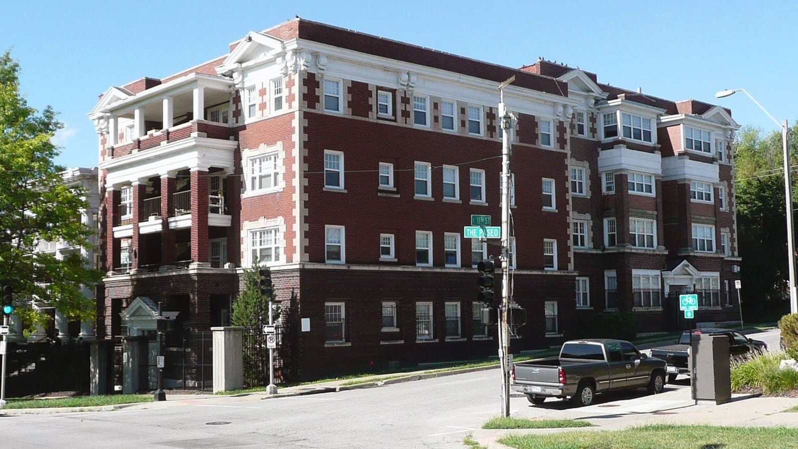 Brick apartment building with white balconies
