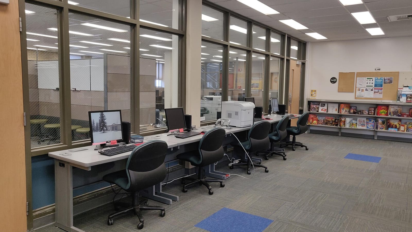 Library computer workstations with empty chairs