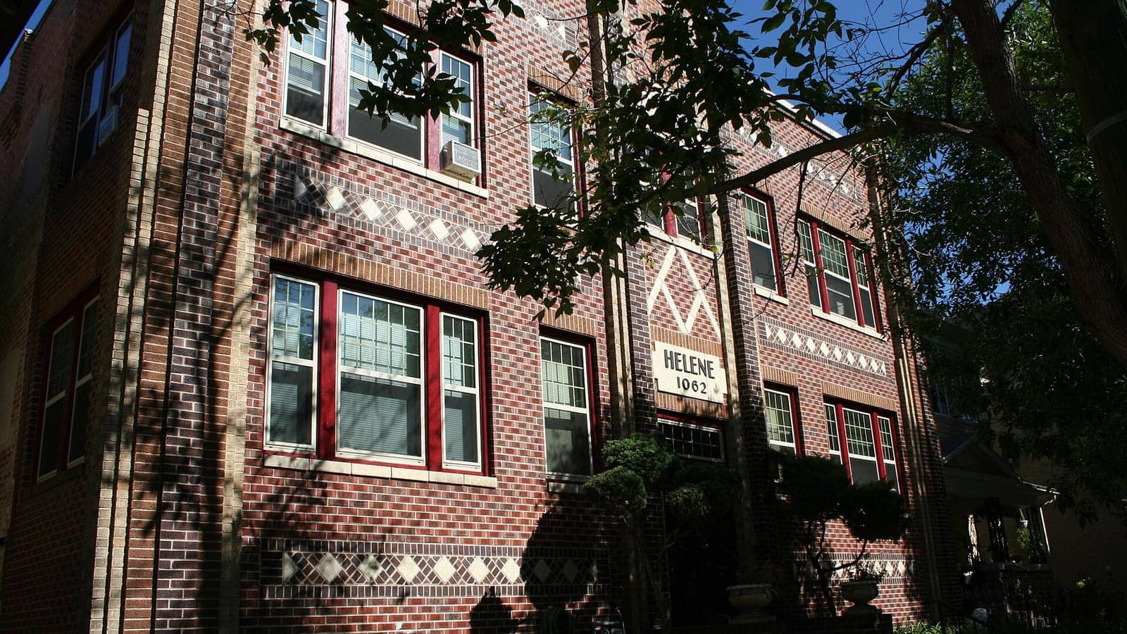 The brick facade of the Helene Apartment Building at 1062 Pearl Street in Denver, Colorado