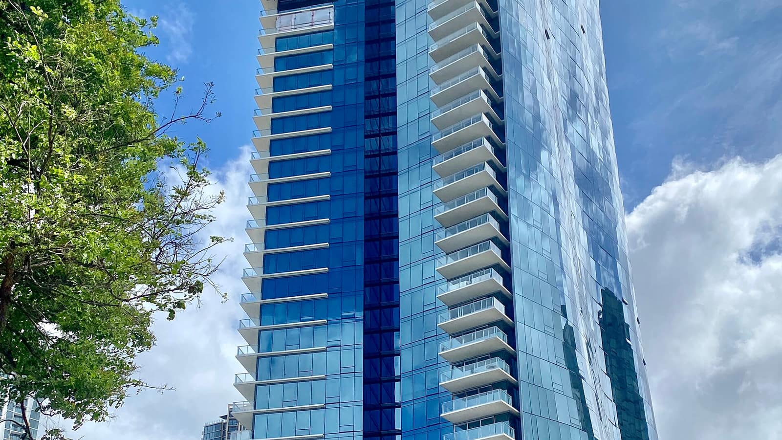 Glass condominium tower with an undulating facade