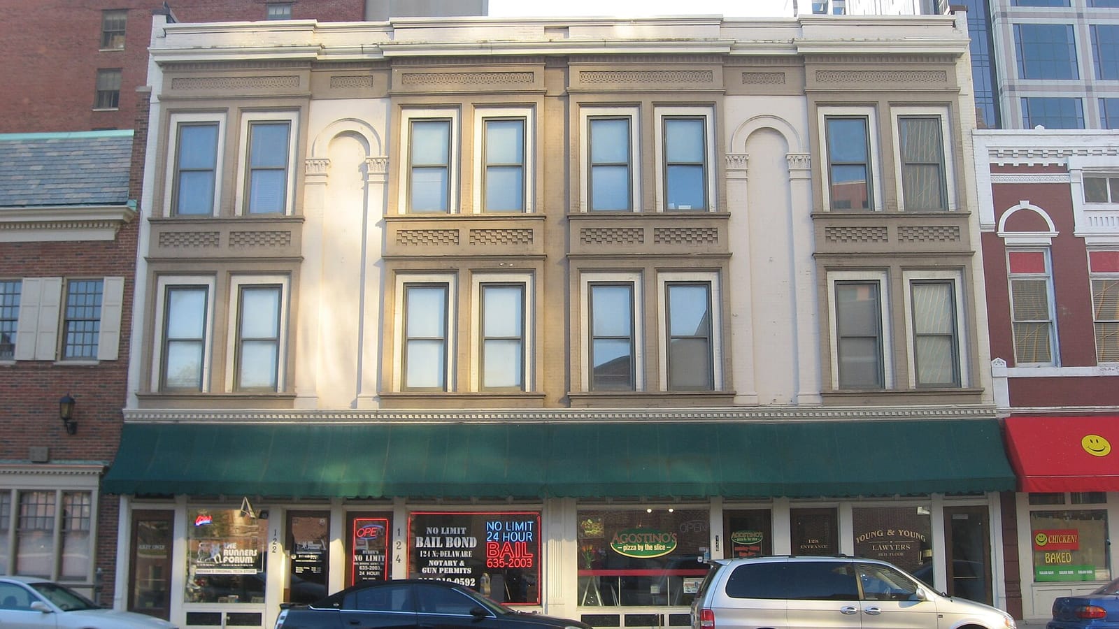 Older apartment building with bay windows above ground-floor storefronts
