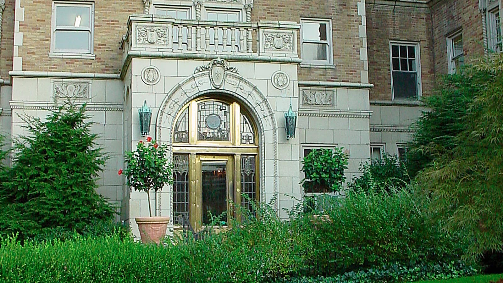 Ornate apartment entrance with pale carved stone details