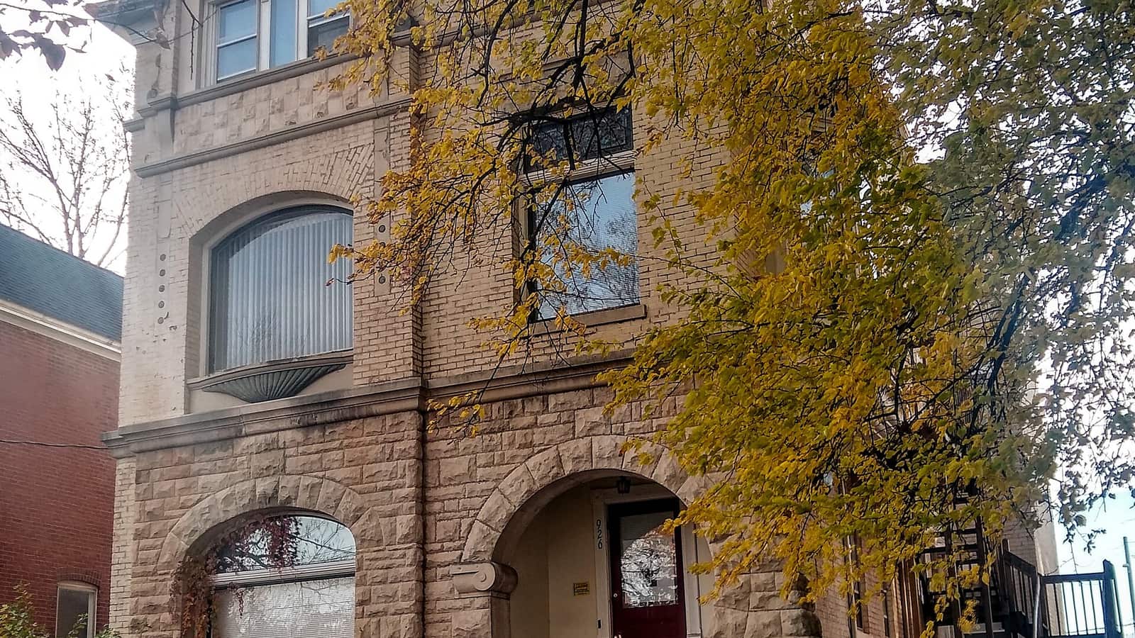Brick residential facade with a tall arched doorway