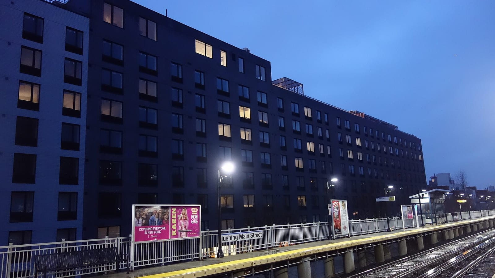 Apartment building with illuminated windows at dusk