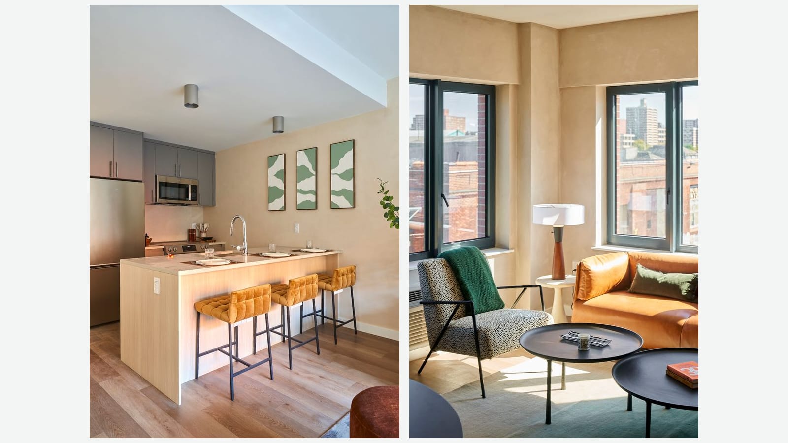 Two photographs side by side of a furnished apartment: at left a kitchen with gray upper cabinets, a stainless-steel refrigerator and microwave, and a light wood island with three orange bar stools; at right a sunny corner living room with two large windows, an orange leather sofa, a spotted armchair and two round black tables, with low brick buildings and a tall brick apartment tower outside