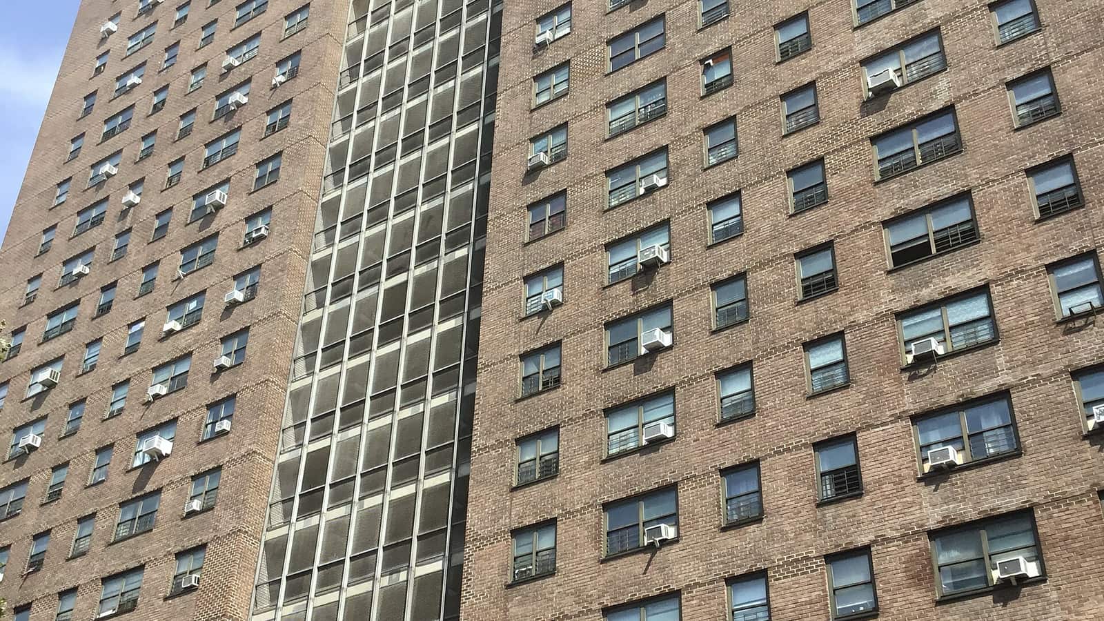 Brick apartment facade with rows of windows