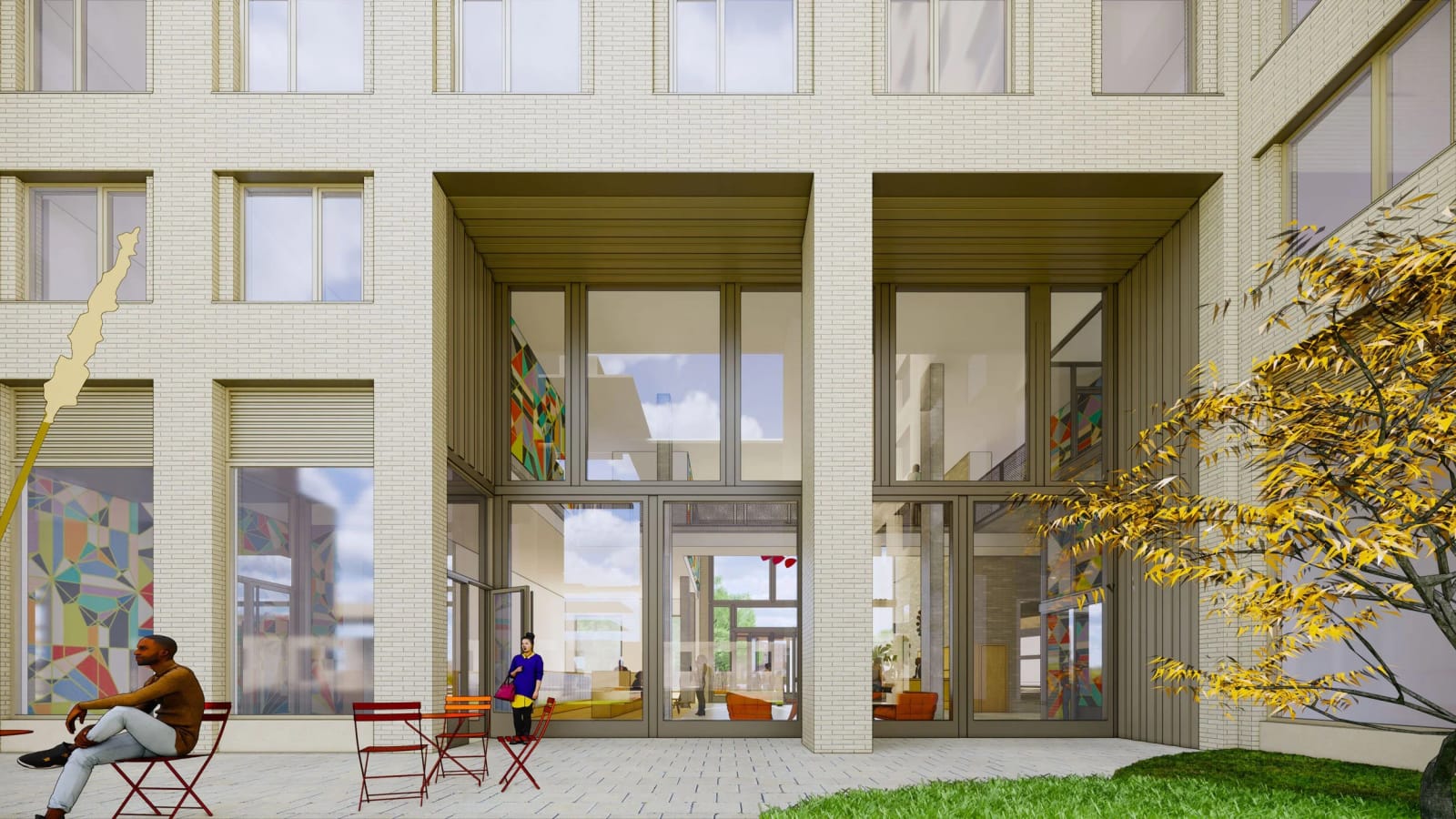 Rendering of a paved courtyard with red and orange folding chairs and a small table, a person seated at left, a tree with yellow leaves at right, and a pale brick building with two-story glazed openings looking into a lobby with colorful wall panels