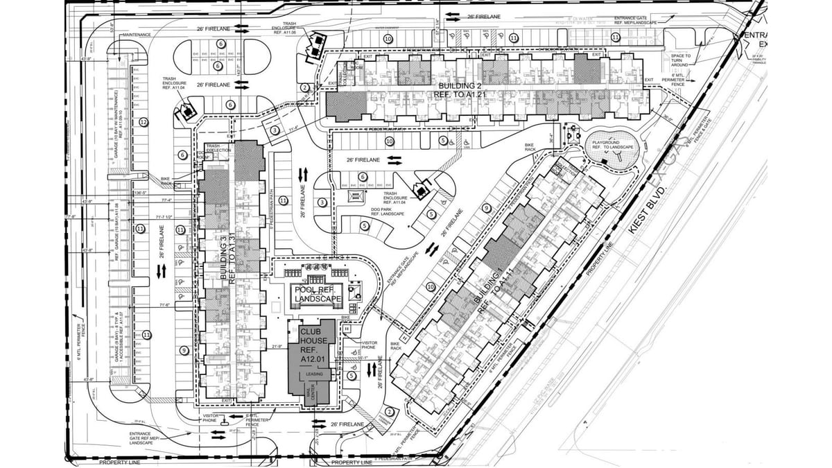Black-and-white architectural site plan showing three long apartment buildings, a clubhouse beside a pool, a playground, a dog park, rows of garages and parking, with Kiest Boulevard along one edge and Southerland Avenue along another