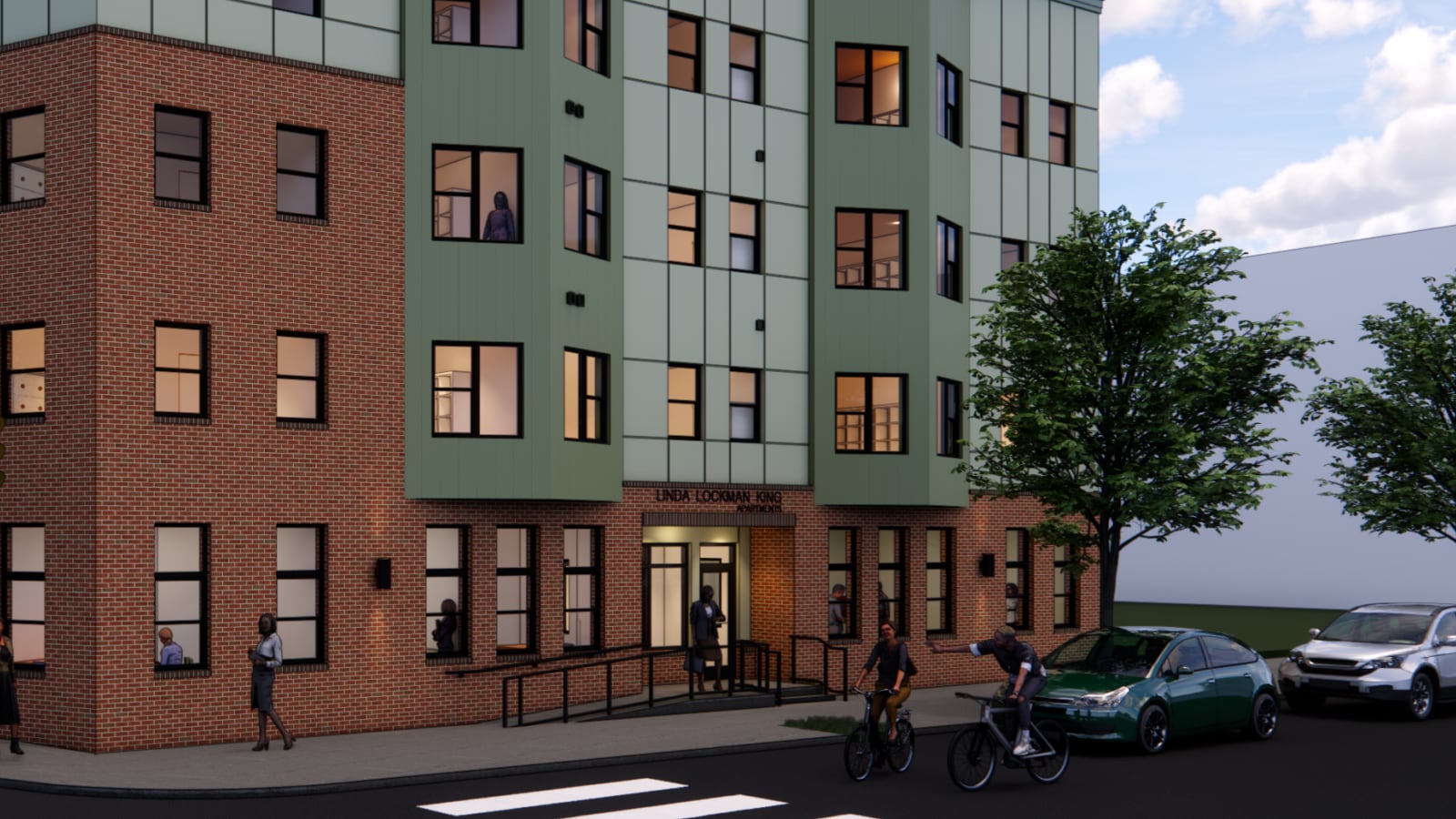 Rendering detail of a brick ground floor with the name Linda Lockman King Apartments over a lit entrance, a ramp with railings and green panel bays above