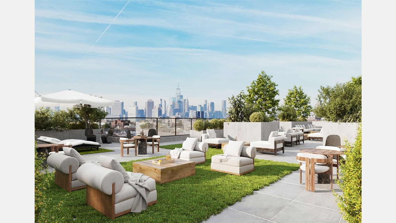 Rendering of a rooftop terrace with artificial grass, white cushioned lounge chairs, wood tables, an umbrella and planters, with low Brooklyn buildings and the Lower Manhattan skyline in the distance under a blue sky