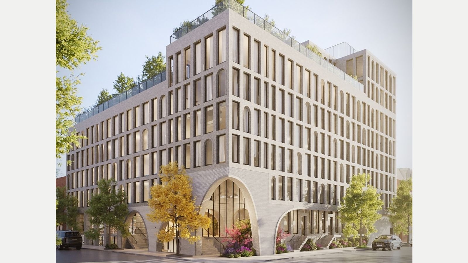 Rendering of a nine-floor apartment building of pale gray brick on a street corner, with a grid of tall rectangular and arched windows, a tall arched entrance at the corner, smaller arches along both streets, stoops with railings, a planted roof terrace with glass railings, street trees and two parked cars